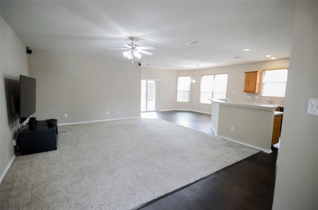 708 Flora Vista Ct, Arlington, TX 76002 - unfurnished living room with ceiling fan, baseboards, recessed lighting, a chandelier, and dark wood-type flooring
