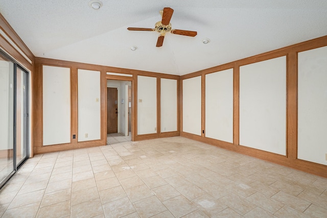 spare room featuring vaulted ceiling and a ceiling fan