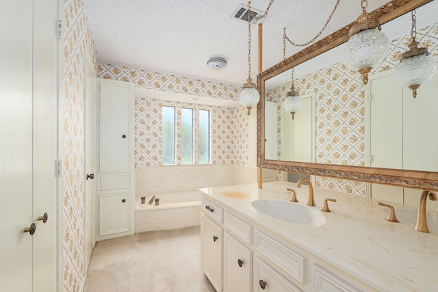 bathroom featuring vanity, a bath, and wallpapered walls