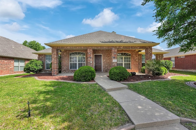 1424 Greenwich Dr, Allen, TX 75013 - view of front of home featuring brick siding, a front yard, and a shingled roof