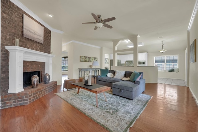1424 Greenwich Dr, Allen, TX 75013 - living area with healthy amount of natural light, wood finished floors, ceiling fan, a fireplace, and ornamental molding