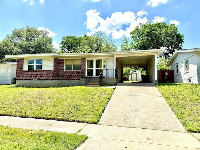 view of front of house featuring driveway, brick siding, and an attached carport