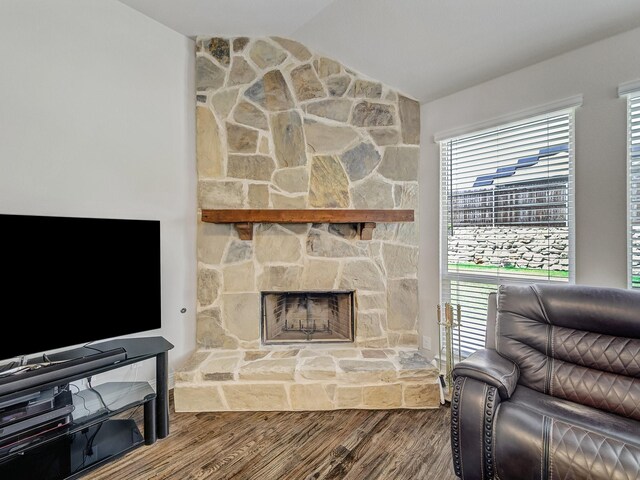 1316 Brentfield Dr, Anna, TX 75409 - living area with lofted ceiling, wood finished floors, plenty of natural light, and a stone fireplace