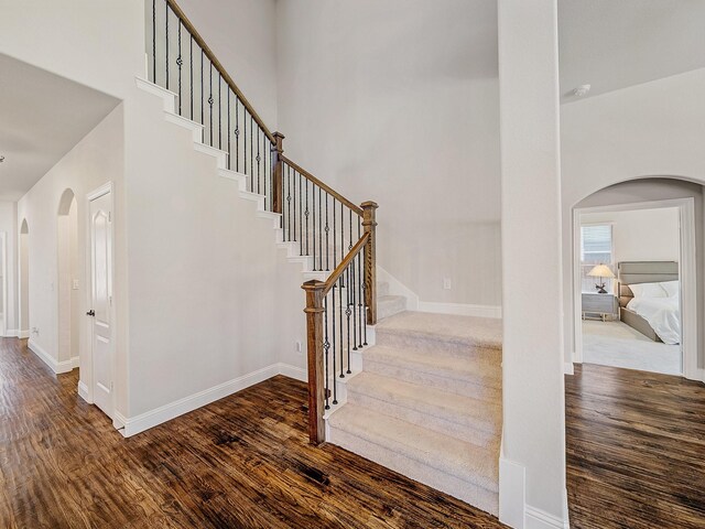 1316 Brentfield Dr, Anna, TX 75409 - stairs with arched walkways, wood finished floors, baseboards, and a high ceiling