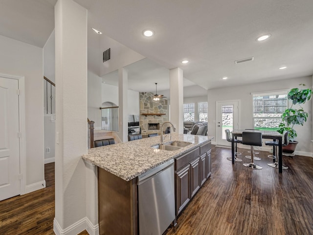 1316 Brentfield Dr, Anna, TX 75409 - kitchen featuring stainless steel dishwasher, a sink, dark wood finished floors, light stone countertops, and open floor plan