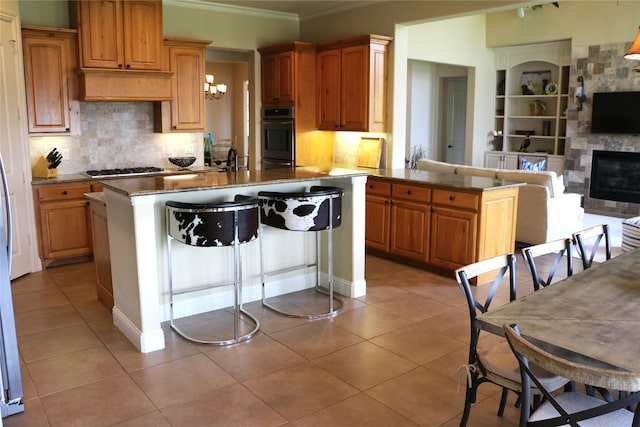 11 Westview Dr, Star Harbor, TX 75148 - kitchen featuring ornamental molding, decorative backsplash, light tile patterned floors, a center island with sink, and a chandelier