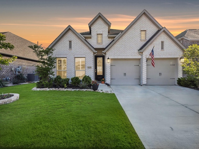 1227 Rushcroft Way, Forney, TX 75126 - view of front of house featuring concrete driveway, a lawn, central AC unit, brick siding, and a garage