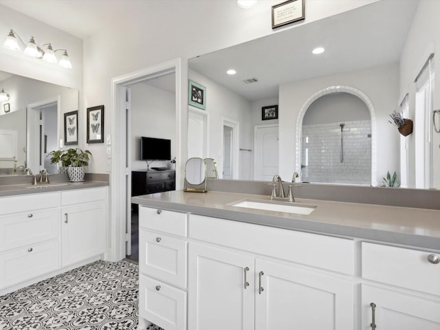1227 Rushcroft Way, Forney, TX 75126 - bathroom featuring a tile shower, two vanities, and recessed lighting