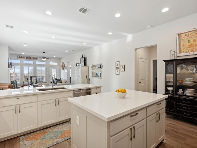 1227 Rushcroft Way, Forney, TX 75126 - kitchen with a sink, wood finished floors, a kitchen island, ceiling fan, and recessed lighting