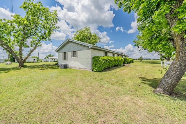 9820 County Road 514, Alvarado, TX 76009 - view of property exterior with brick siding, a lawn, and central air condition unit