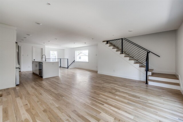 1612 Grigsby Ave Unit 101, Dallas, TX 75204 - unfurnished living room featuring light wood-type flooring, baseboards, and recessed lighting