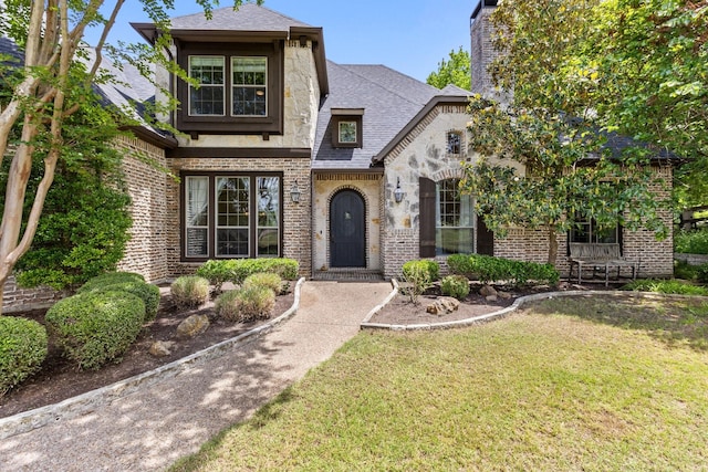 1480 Snider Ct, Lucas, TX 75002 - view of front of house featuring brick siding, a front lawn, a chimney, a shingled roof, and stone siding