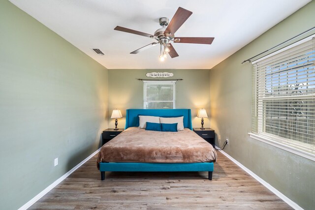 1809 Esquire Pl, Grand Prairie, TX 75050 - bedroom with multiple windows, wood finished floors, baseboards, and ceiling fan