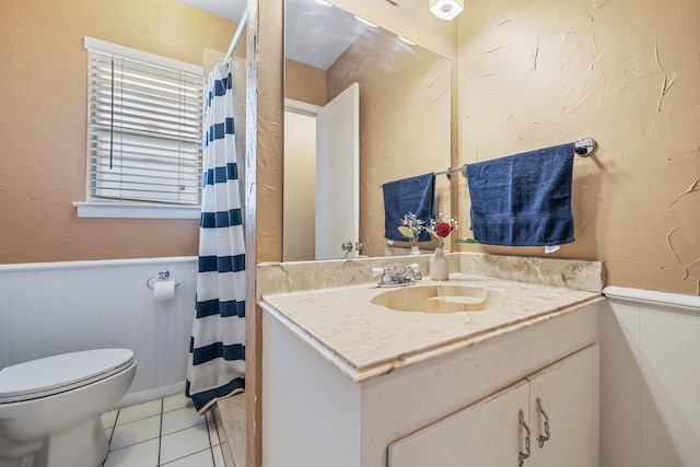 1809 Esquire Pl, Grand Prairie, TX 75050 - full bathroom featuring a wainscoted wall, toilet, vanity, tile patterned flooring, and a shower with curtain