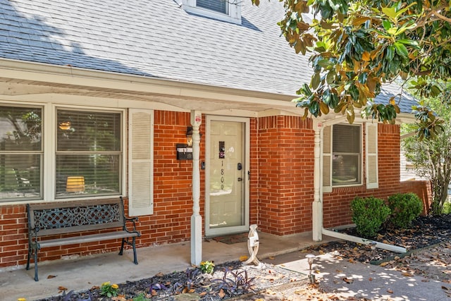 1809 Esquire Pl, Grand Prairie, TX 75050 - doorway to property with roof with shingles, brick siding, and a porch