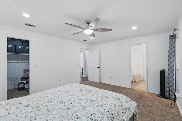 6801 Sweetwater Dr, Plano, TX 75023 - carpeted bedroom featuring recessed lighting, a walk in closet, ensuite bathroom, baseboards, and a ceiling fan