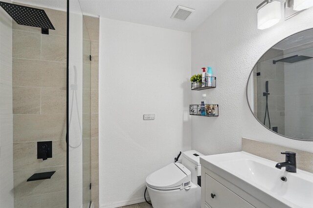 6801 Sweetwater Dr, Plano, TX 75023 - full bath featuring a stall shower, toilet, a textured wall, and vanity