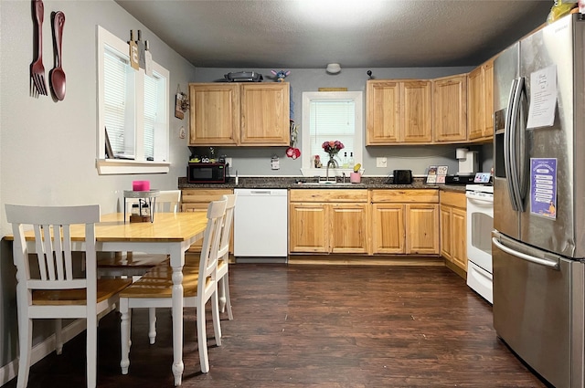 310 W Russell St, Weatherford, TX 76086 - kitchen featuring white appliances, a sink, plenty of natural light, and dark countertops