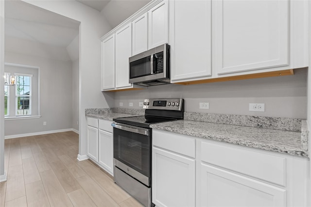 3625 Beutel Rd, Waco, TX 76655 - kitchen with stainless steel appliances, baseboards, white cabinetry, light wood-style flooring, and light stone countertops