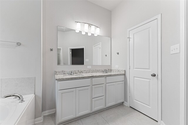 3625 Beutel Rd, Waco, TX 76655 - bathroom with a bath, double vanity, and baseboards