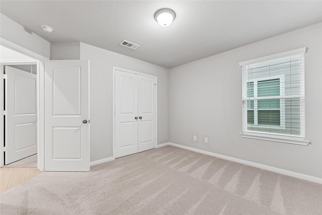 3625 Beutel Rd, Waco, TX 76655 - unfurnished bedroom with carpet floors, baseboards, a closet, and a textured ceiling