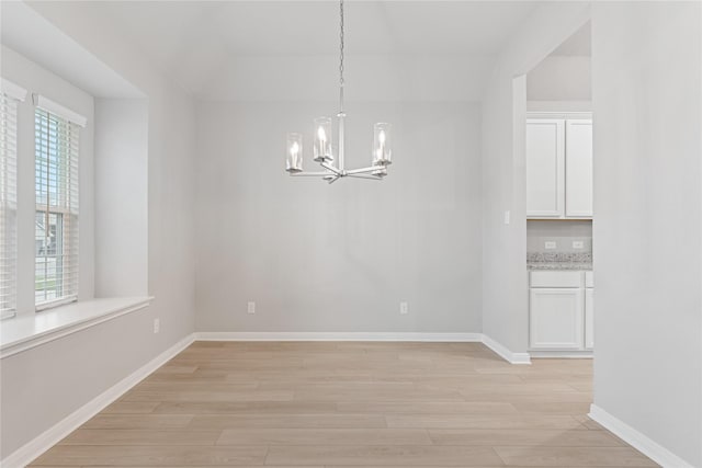 3625 Beutel Rd, Waco, TX 76655 - unfurnished dining area with a chandelier, light wood-style flooring, and baseboards