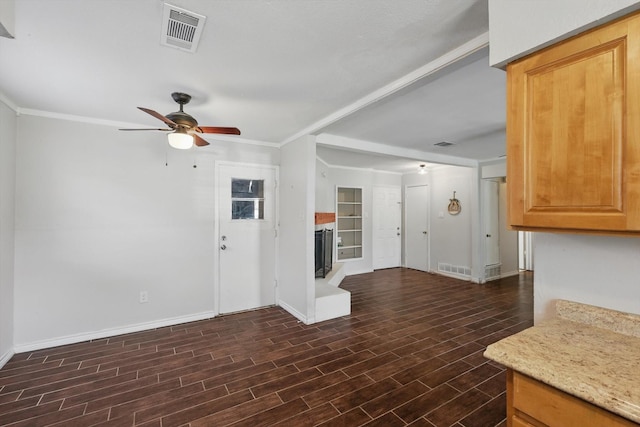 6529 Wooddale Dr, Watauga, TX 76148 - unfurnished living room with baseboards, a ceiling fan, dark wood-type flooring, a fireplace with raised hearth, and ornamental molding
