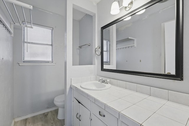 6529 Wooddale Dr, Watauga, TX 76148 - bathroom with toilet, wood finished floors, vanity, and baseboards