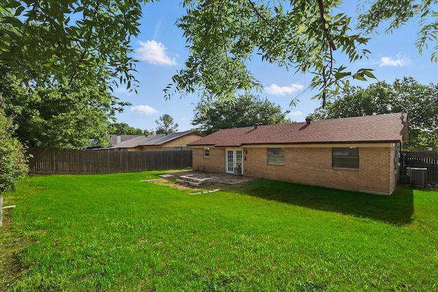 6529 Wooddale Dr, Watauga, TX 76148 - rear view of property with french doors, brick siding, a patio area, and central AC