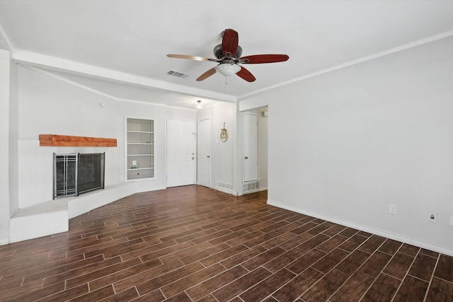 6529 Wooddale Dr, Watauga, TX 76148 - unfurnished living room with ceiling fan, built in shelves, baseboards, and wood finished floors
