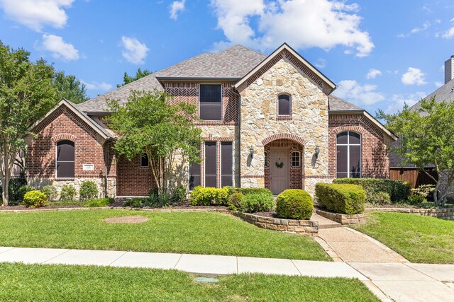 701 Mason Dr, Allen, TX 75013 - view of front of home with stone siding, a front lawn, brick siding, and roof with shingles