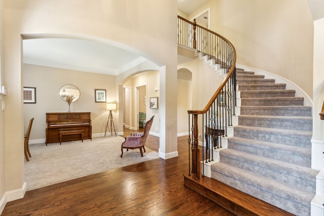 701 Mason Dr, Allen, TX 75013 - entryway featuring arched walkways, wood finished floors, stairs, baseboards, and crown molding