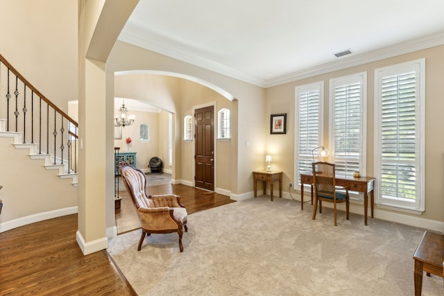 701 Mason Dr, Allen, TX 75013 - living area featuring arched walkways, a chandelier, ornamental molding, stairway, and baseboards