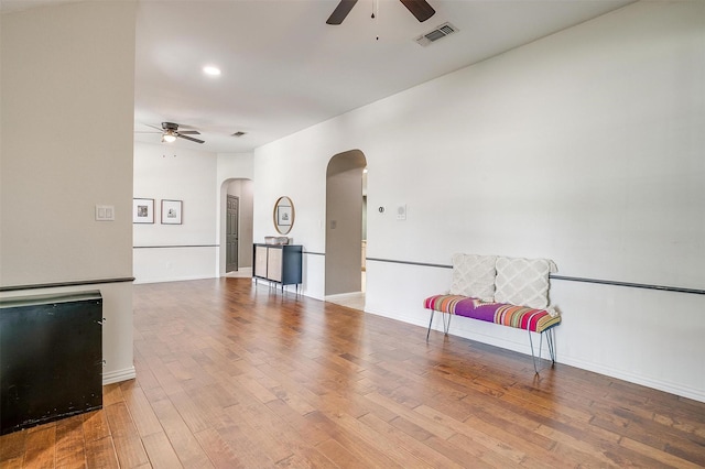 1100 Highcrest Dr, Burleson, TX 76028 - spare room featuring ceiling fan, arched walkways, wood finished floors, and baseboards