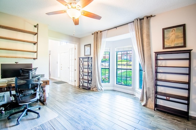 8200 Edgewater Dr, Frisco, TX 75034 - home office featuring wood finished floors, baseboards, and a textured ceiling