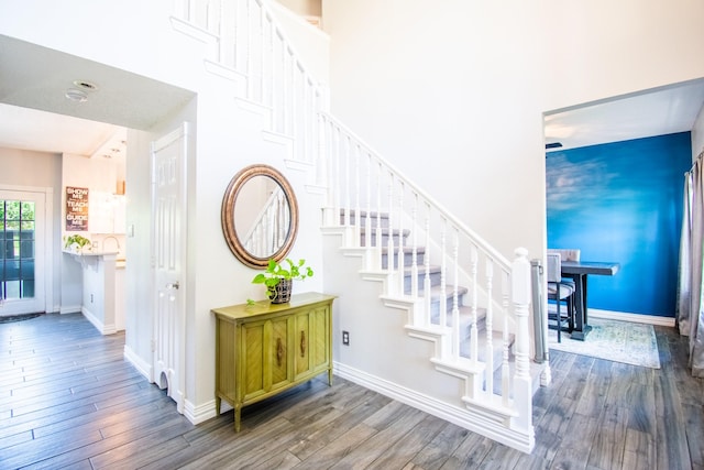 8200 Edgewater Dr, Frisco, TX 75034 - staircase featuring wood finished floors, baseboards, and a towering ceiling