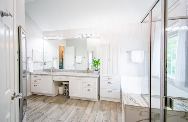 8200 Edgewater Dr, Frisco, TX 75034 - bathroom featuring wood finished floors, double vanity, and a shower with shower door