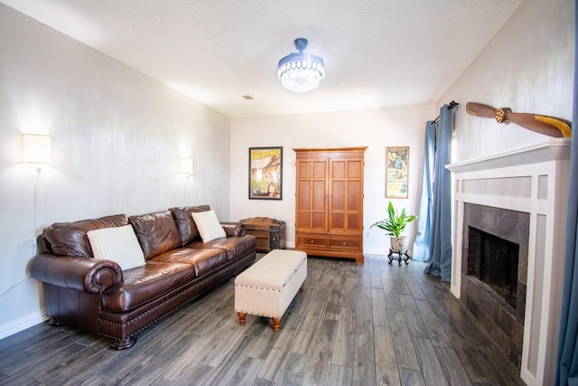8200 Edgewater Dr, Frisco, TX 75034 - living area featuring wood finished floors, baseboards, a fireplace, and a textured ceiling