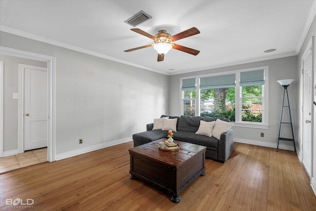 living room with a ceiling fan, baseboards, wood finished floors, and crown molding