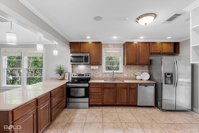 kitchen with appliances with stainless steel finishes, a sink, backsplash, ornamental molding, and a peninsula