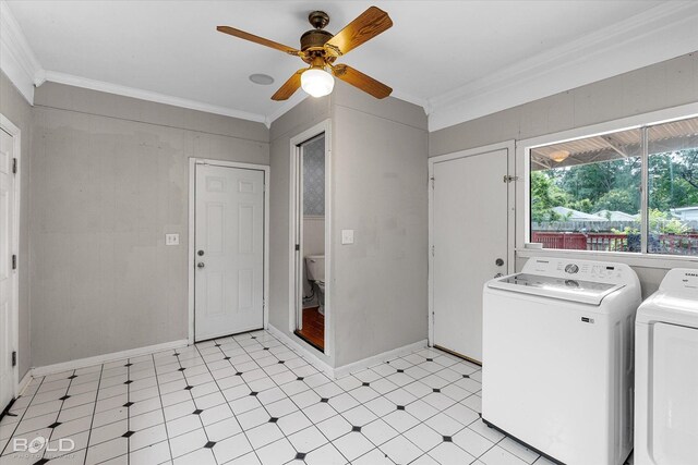 washroom with washing machine and dryer, light flooring, ornamental molding, a ceiling fan, and baseboards