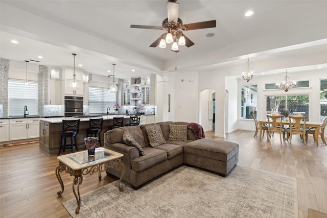 731 Bradford St, Lantana, TX 76226 - living room with arched walkways, light wood-type flooring, a chandelier, ceiling fan, and recessed lighting