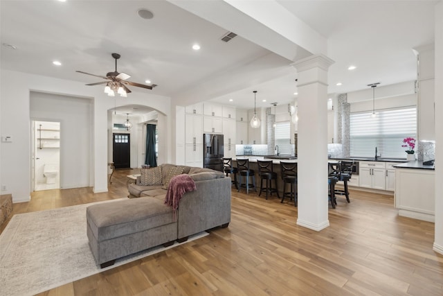 731 Bradford St, Lantana, TX 76226 - living area with a ceiling fan, light wood finished floors, recessed lighting, ornate columns, and arched walkways