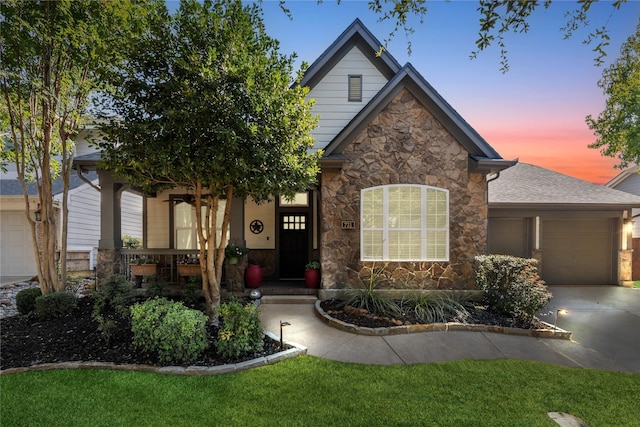 731 Bradford St, Lantana, TX 76226 - view of front of house featuring stone siding, an attached garage, concrete driveway, and a porch