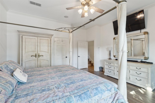 731 Bradford St, Lantana, TX 76226 - bedroom featuring wood finished floors, crown molding, two closets, and ceiling fan