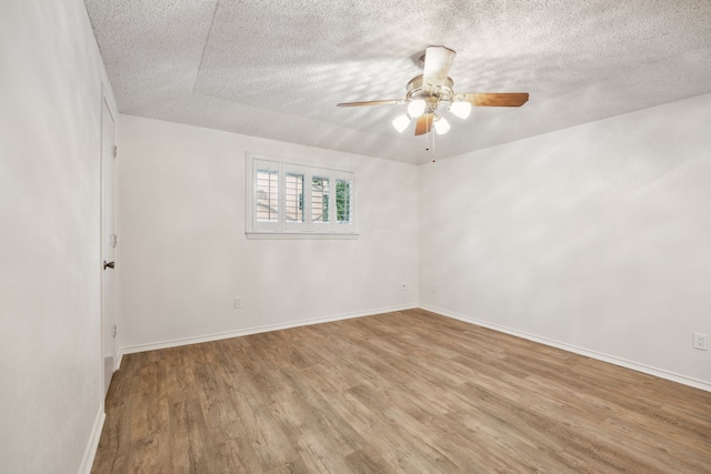 731 N Horne St, Duncanville, TX 75116 - empty room with wood finished floors, a ceiling fan, a textured ceiling, and baseboards