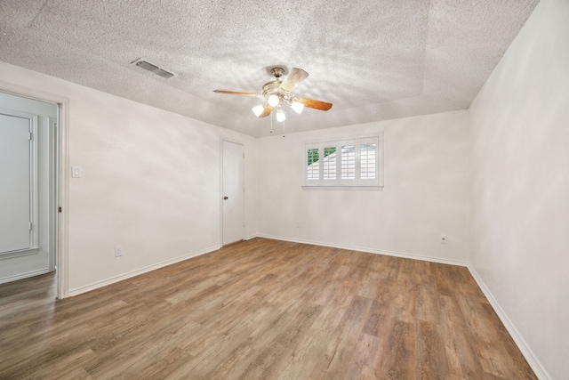731 N Horne St, Duncanville, TX 75116 - spare room with wood finished floors, a textured ceiling, a ceiling fan, and baseboards
