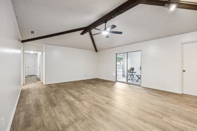 731 N Horne St, Duncanville, TX 75116 - unfurnished living room with a ceiling fan, a textured ceiling, light wood-style flooring, and baseboards