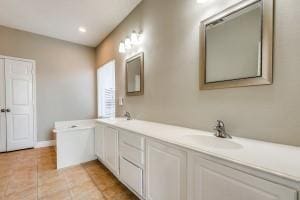 2789 Coyote Trl, Little Elm, TX 75068 - bathroom with tile patterned floors, double vanity, baseboards, and recessed lighting