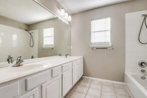 2789 Coyote Trl, Little Elm, TX 75068 - bathroom featuring tile patterned flooring, shower / bath combination, baseboards, and double vanity